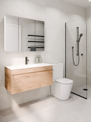 Modern bathroom with wooden vanity, toilet, and shower enclosure.