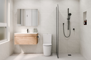 Modern bathroom with wooden vanity, toilet, and shower area.