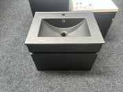 A modern wall-mounted bathroom vanity with a matte black cabinet and a dark gray integrated sink basin clearance sale deal