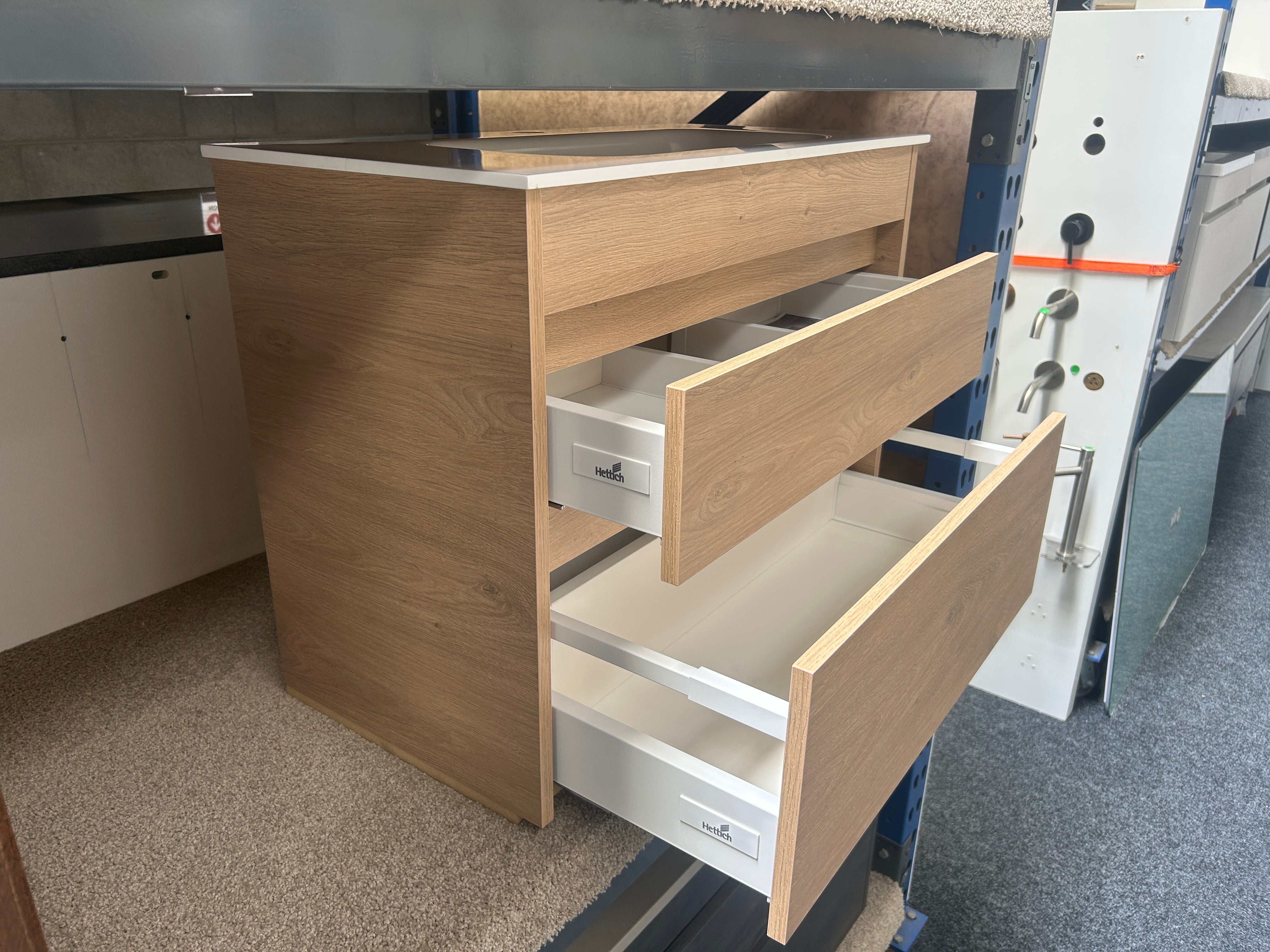 A wooden drawer cabinet with two pull-out drawers partially extended clearance deal sale