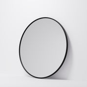 Round mirror with a black frame on a white background